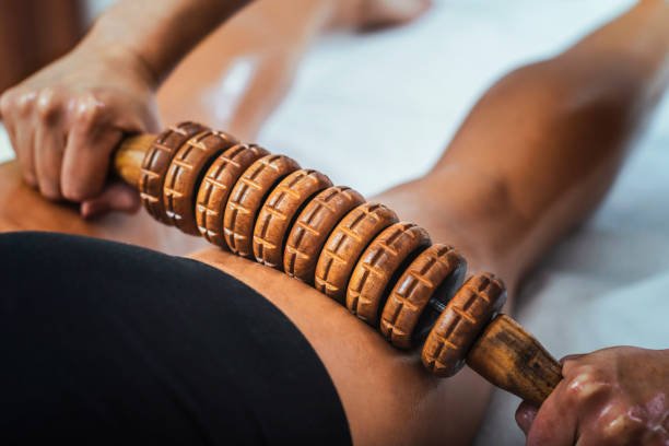 Madero therapy back thigh muscle massage with wooden rolling pin or battledore